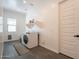 Bright laundry room with front load washer/dryer and white walls at 9960 E Strobe Ave, Mesa, AZ 85212