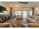 Bright living room featuring a ceiling fan, large sofas, and access to the outdoor patio at 9960 E Strobe Ave, Mesa, AZ 85212