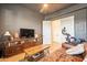 Comfortable living room includes wood floors, entertainment center, and natural light at 9960 E Strobe Ave, Mesa, AZ 85212