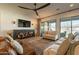Spacious living room with a ceiling fan, large sliding glass doors, and comfortable seating at 9960 E Strobe Ave, Mesa, AZ 85212