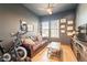 Cozy living room featuring wood floors, neutral paint, leather sofa, and natural light at 9960 E Strobe Ave, Mesa, AZ 85212