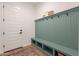 Convenient mudroom with built-in bench, coat hooks, and storage cubbies, providing practical organization at 9960 E Strobe Ave, Mesa, AZ 85212