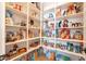 Walk-in pantry featuring ample shelving filled with various food items and household supplies at 9960 E Strobe Ave, Mesa, AZ 85212