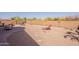 The backyard features desert landscaping, a firepit, and mature desert trees at 10368 E Gold Nugget Ct, Gold Canyon, AZ 85118