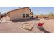 Large, landscaped backyard featuring a patio area, fire pit, and mountain views at 10368 E Gold Nugget Ct, Gold Canyon, AZ 85118