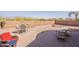 Paver patio backyard with ample seating, desert landscaping, and a block perimeter wall at 10368 E Gold Nugget Ct, Gold Canyon, AZ 85118
