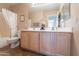 Bright bathroom featuring a double sink vanity, a large mirror, and a shower with curtain at 10368 E Gold Nugget Ct, Gold Canyon, AZ 85118