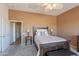 Bedroom has a large bed, neutral tones, and an open doorway to the home's hallway at 10368 E Gold Nugget Ct, Gold Canyon, AZ 85118