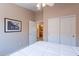 Bedroom with ceiling fan, closet, doorway to the adjacent bathroom and neutral colored walls at 10368 E Gold Nugget Ct, Gold Canyon, AZ 85118