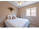 Bedroom features a window with a view of the home exterior, carpet and a ceiling fan at 10368 E Gold Nugget Ct, Gold Canyon, AZ 85118