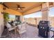 An inviting covered patio includes a dining area and grill, perfect for outdoor entertaining at 10368 E Gold Nugget Ct, Gold Canyon, AZ 85118