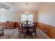 Elegant dining room featuring a chandelier, wood paneling, and a round table with seating for six at 10368 E Gold Nugget Ct, Gold Canyon, AZ 85118
