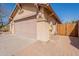 View of the two car garage door and address, with a walkway leading to a gate at 10368 E Gold Nugget Ct, Gold Canyon, AZ 85118