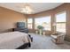 Sunlit main bedroom with large windows, neutral carpet, and a ceiling fan at 10368 E Gold Nugget Ct, Gold Canyon, AZ 85118