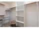 Large walk-in closet with shelving, wooden rails and a wire rack for shoe or accessory storage at 10368 E Gold Nugget Ct, Gold Canyon, AZ 85118