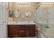 Bathroom features double sinks, oval mirrors, and a glass-enclosed shower/tub at 10421 W Via Del Sol -- # 379, Peoria, AZ 85383