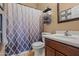 Bathroom showcasing a patterned shower curtain, a single sink vanity and a decoratively organized towel rack at 10421 W Via Del Sol -- # 379, Peoria, AZ 85383