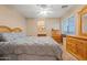 Bedroom with plush bedding, wood furniture, and an ensuite bathroom view at 10421 W Via Del Sol -- # 379, Peoria, AZ 85383