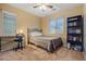 Bedroom with a desk, iron bed frame and dark bookcase at 10421 W Via Del Sol -- # 379, Peoria, AZ 85383