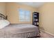 Neutral bedroom with an iron bed frame and a full bookcase near a large window at 10421 W Via Del Sol -- # 379, Peoria, AZ 85383