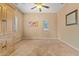 Neutral bedroom with carpet, tan walls, large cabinet, ceiling fan, and two windows with blinds at 10421 W Via Del Sol -- # 379, Peoria, AZ 85383