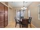 A light-filled dining area featuring access to the backyard, chandelier and tile flooring at 10421 W Via Del Sol -- # 379, Peoria, AZ 85383