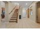 Welcoming entryway with staircase and tile flooring, leading to the living spaces at 10421 W Via Del Sol -- # 379, Peoria, AZ 85383