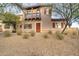 Inviting two-story home featuring a charming balcony and desert landscaping at 10421 W Via Del Sol -- # 379, Peoria, AZ 85383