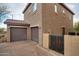 Exterior shot of a two-story home with a two-car garage and gated access, showcasing its architectural style and curb appeal at 10421 W Via Del Sol -- # 379, Peoria, AZ 85383