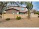 Backyard view of a stucco home with a terracotta roof, complete with a wooden pergola and desert landscaping at 10421 W Via Del Sol -- # 379, Peoria, AZ 85383