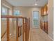 Upstairs hallway featuring natural light, wooden railing, and convenient cabinet storage space at 10421 W Via Del Sol -- # 379, Peoria, AZ 85383
