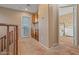 Bright hallway with outdoor access and an open doorway to a cozy bedroom featuring a large window at 10421 W Via Del Sol -- # 379, Peoria, AZ 85383