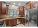 Well-lit kitchen featuring stainless steel appliances, wooden cabinets, tile floors and a double basin sink at 10421 W Via Del Sol -- # 379, Peoria, AZ 85383