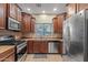 Modern kitchen featuring stainless steel appliances, wood cabinets, and natural light at 10421 W Via Del Sol -- # 379, Peoria, AZ 85383