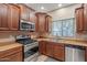 Well-equipped kitchen with stainless steel appliances, and wood cabinets at 10421 W Via Del Sol -- # 379, Peoria, AZ 85383