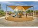 Community playground with a shaded structure, slides, and swings providing a fun and safe recreational area for children at 10421 W Via Del Sol -- # 379, Peoria, AZ 85383