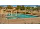 Community pool with a spa, covered seating, and landscaped surroundings at 10421 W Via Del Sol -- # 379, Peoria, AZ 85383