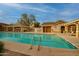 Community swimming pool with clear blue water, lounge chairs, and shaded cabanas, perfect for relaxation and recreation at 10421 W Via Del Sol -- # 379, Peoria, AZ 85383