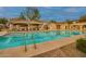 Resort-style community pool with ample lounge seating and well-maintained facilities under a partly cloudy sky at 10421 W Via Del Sol -- # 379, Peoria, AZ 85383