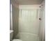 Bathroom featuring shower with built-in seat and shower head at 12221 W Bell Rd # 119, Surprise, AZ 85378