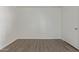 Bedroom features vinyl plank flooring, neutral paint, and single entry door at 12221 W Bell Rd # 119, Surprise, AZ 85378