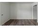 Bedroom features vinyl plank flooring, neutral paint, and single entry door at 12221 W Bell Rd # 119, Surprise, AZ 85378