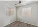 The cozy bedroom features wood floors, white walls, and natural light at 12221 W Bell Rd # 119, Surprise, AZ 85378