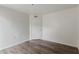 Bright bedroom featuring wood-look flooring and a door for easy access and privacy at 12221 W Bell Rd # 119, Surprise, AZ 85378