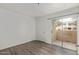 Bright bedroom features vinyl plank flooring, neutral paint, and a private balcony at 12221 W Bell Rd # 119, Surprise, AZ 85378