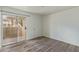 Bright bedroom features vinyl plank flooring, neutral paint, and a private balcony at 12221 W Bell Rd # 119, Surprise, AZ 85378