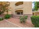 Inviting building exterior showcasing lush landscaping and multiple levels with private balconies at 12221 W Bell Rd # 119, Surprise, AZ 85378