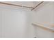 Spacious walk-in closet offering ample storage with wooden rods and shelving at 12221 W Bell Rd # 119, Surprise, AZ 85378
