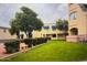 Beautiful courtyard with lush landscaping and mature trees at 12221 W Bell Rd # 119, Surprise, AZ 85378