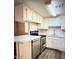 Kitchen featuring stainless steel appliances, white cabinets and countertop, and wood floors at 12221 W Bell Rd # 119, Surprise, AZ 85378